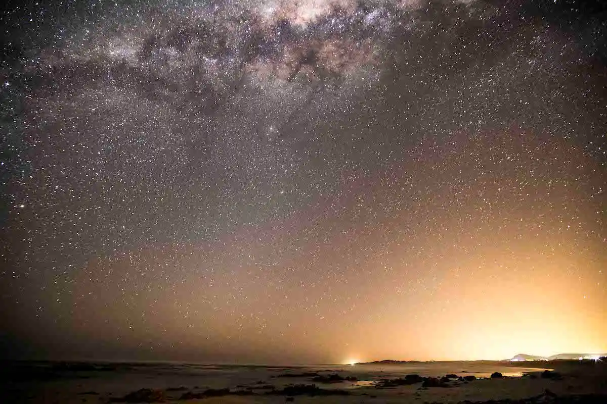 Night sky with brilliant stars over Pearly Beach coastline